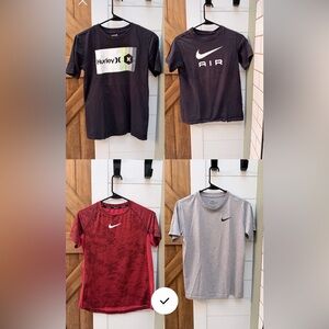 Grey, black and red Nike shirts and 1 Hurley tshirt.